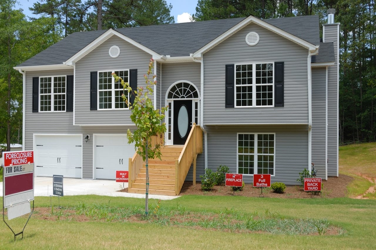 a new house with for sale sign 